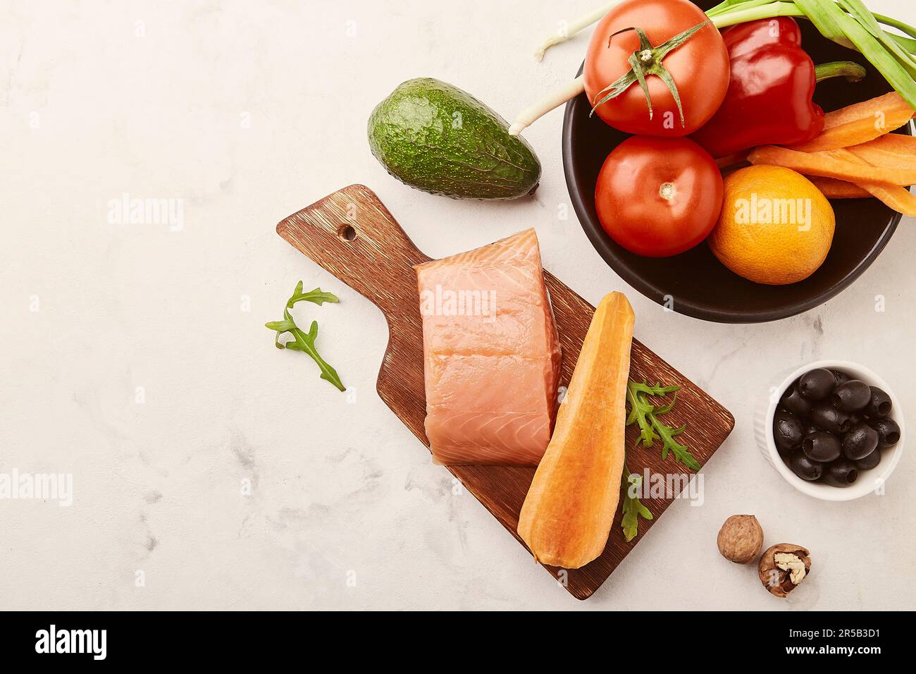 FODMAP, low carb, keto diet -vegetables and fruits, smoked salmon, greens, nuts, olives with copy space. Stock Photo