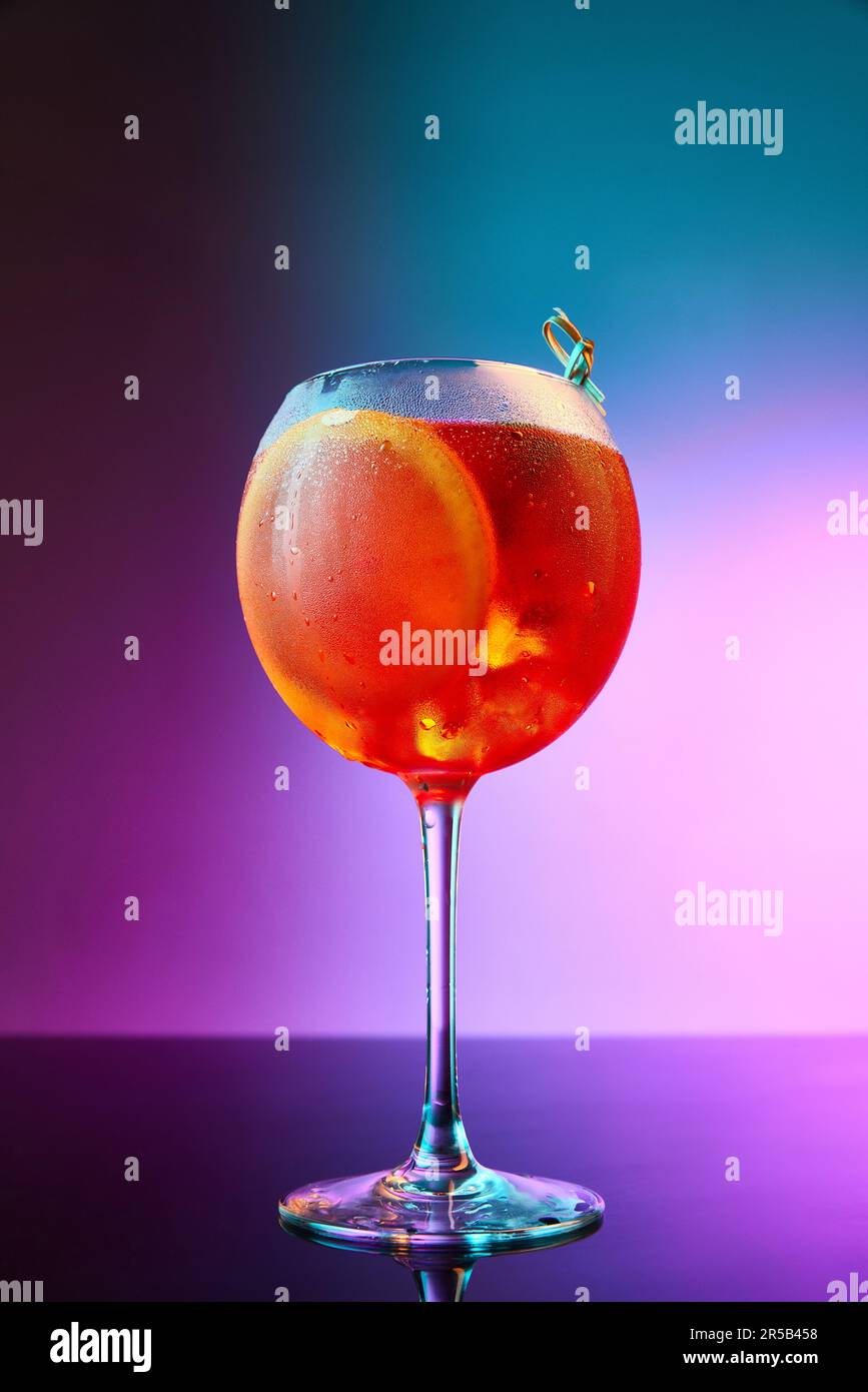 Vibrant portrait with Glass of Aperol Spritz over gradient neon