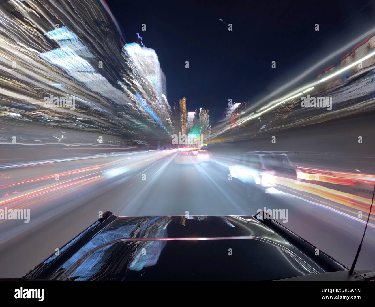 An aerial view of a bustling city street at night, illuminated by the ...