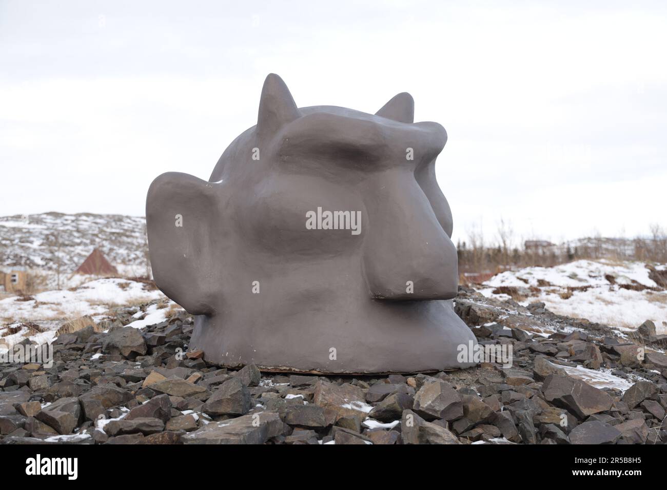 A majestic stone troll statue stands proud in Fossatun, Iceland Stock