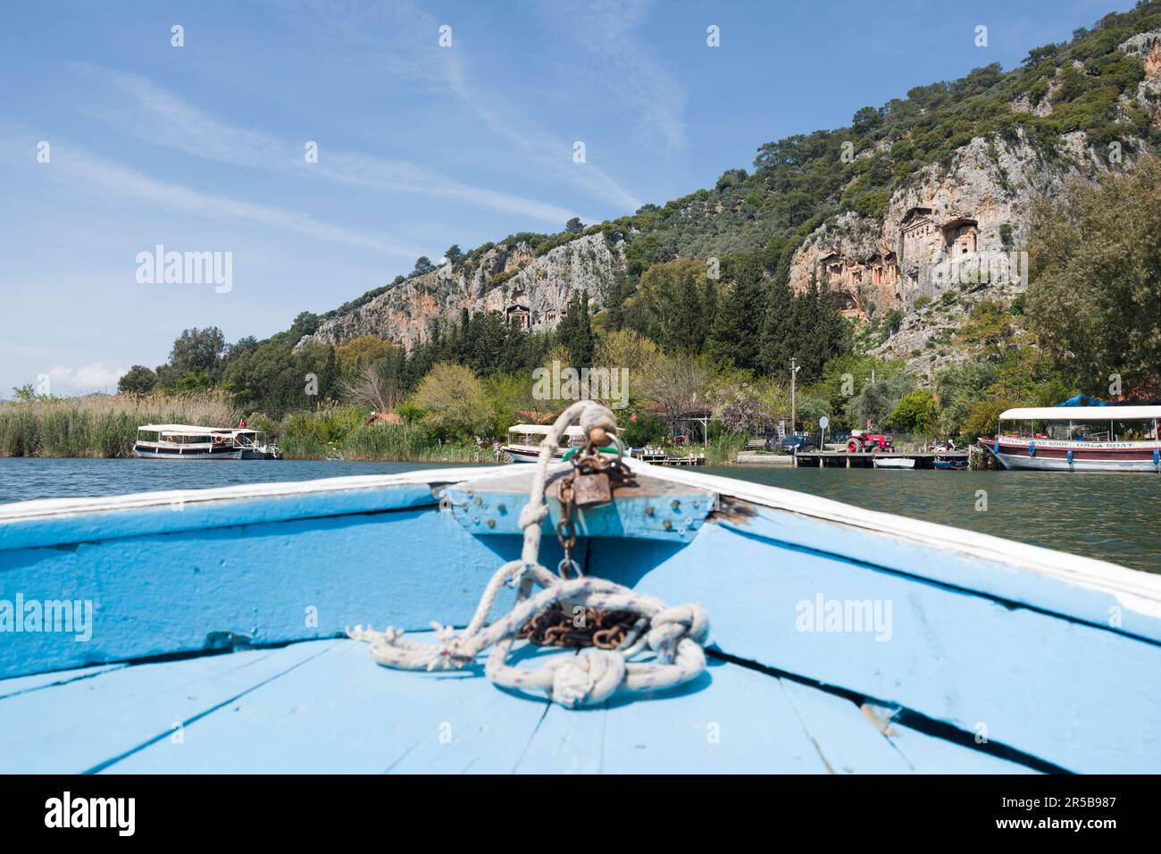 Lycian ancient rock tombs (4th century BC) viewed from a small boat on the Dalyan River, Dalyan, Muğla Province, Turkey, April 2023 Stock Photo
