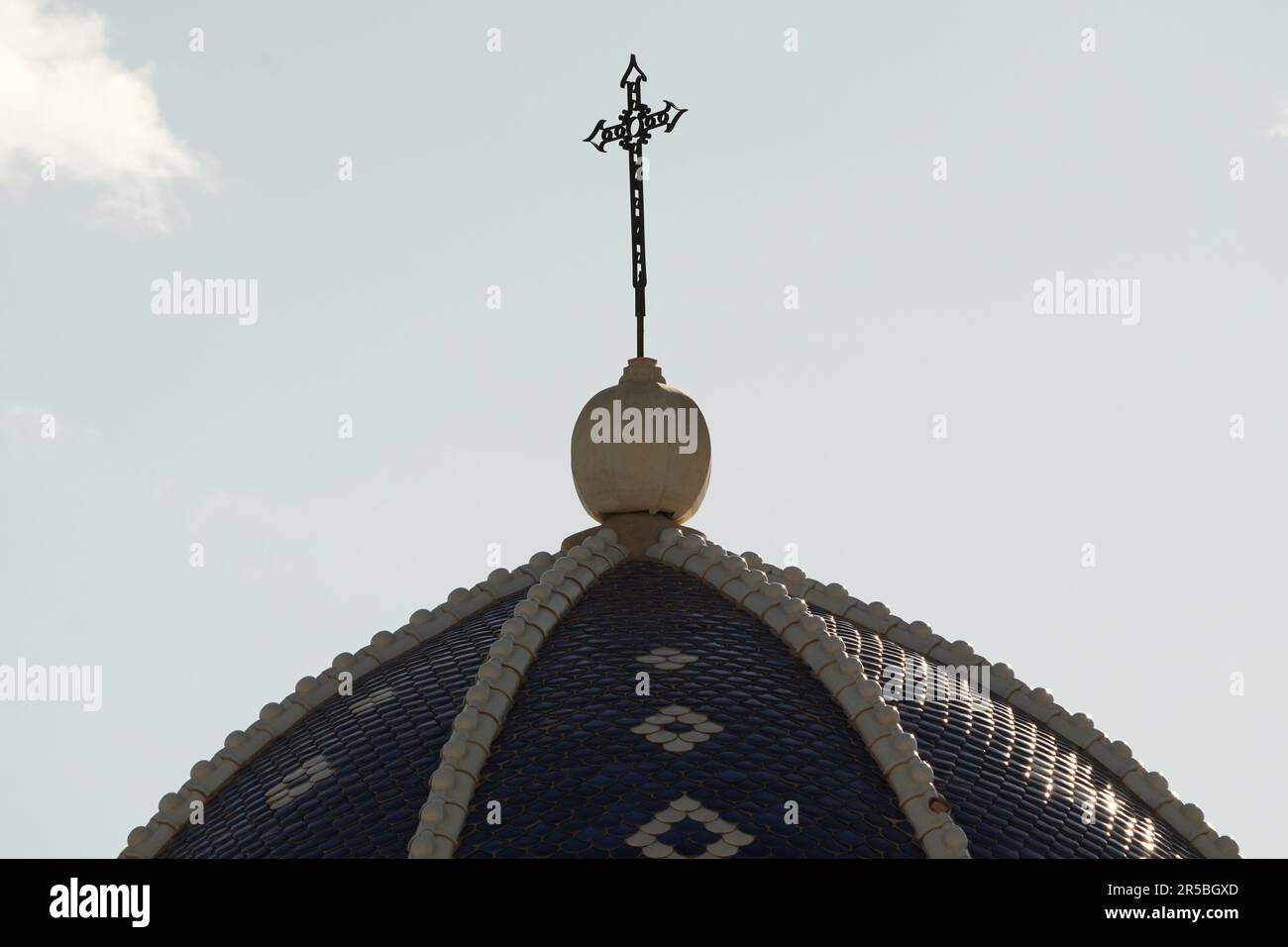An image of a historic building featuring a domed roof, complete with a cross adorning the apex Stock Photo