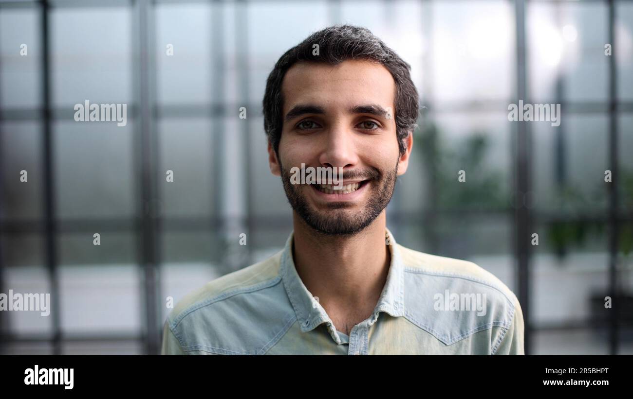Confident young smiling businessman posing on camera Stock Photo