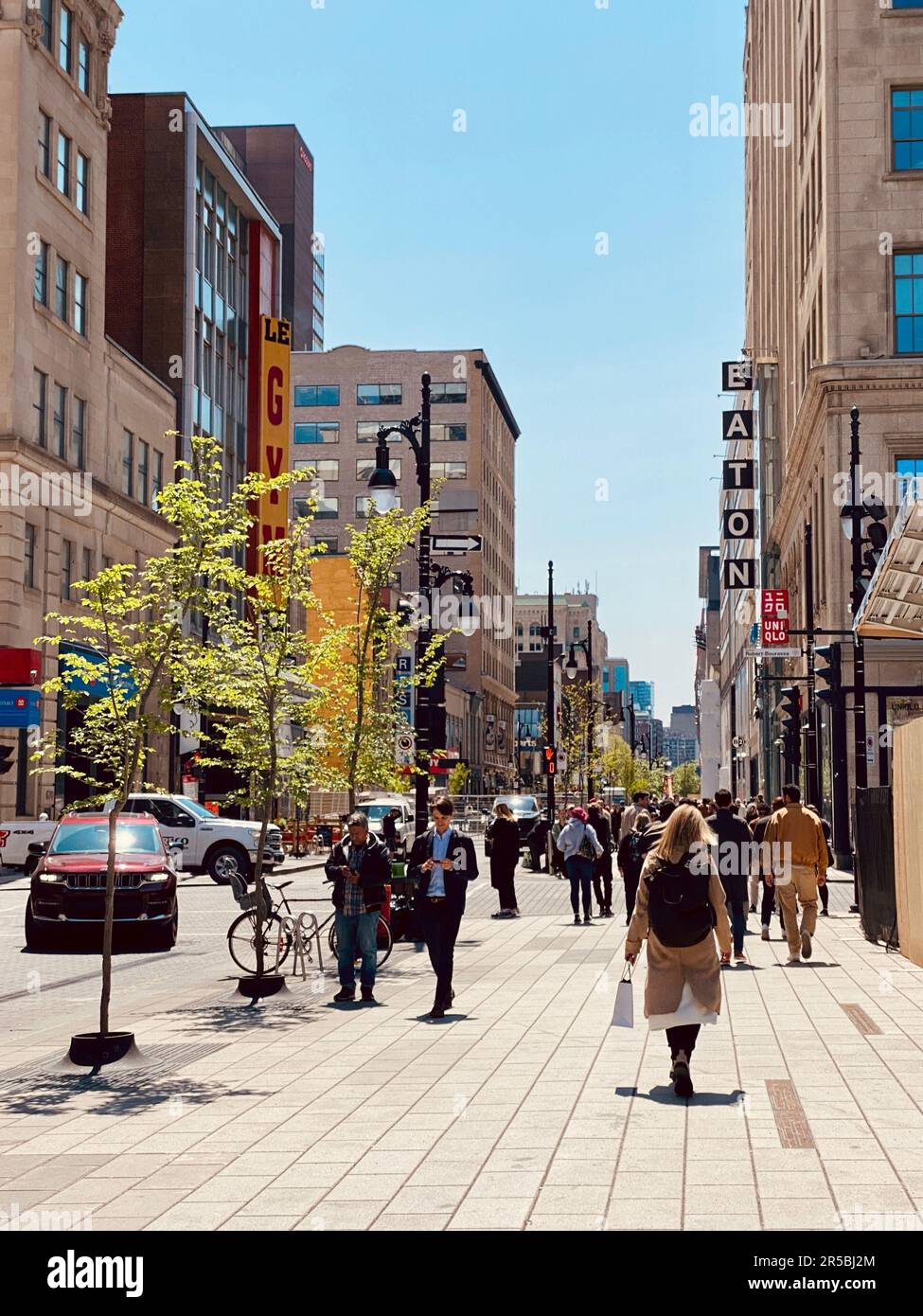The pedestrians walking down St Catherine Street in Montreal, Canada ...