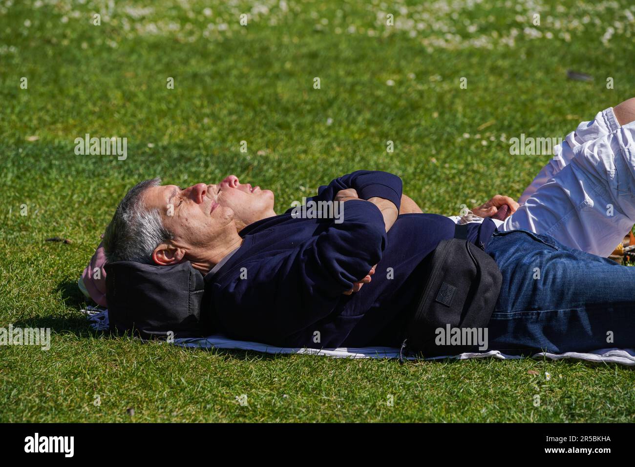 London UK. 2 June 2023 . A couple soaking  the warm sunshine  in Saint James Park . The Met Office forecast warmer temperatures as the country enters the official summer season.Credit: amer ghazzal/Alamy Live News Stock Photo