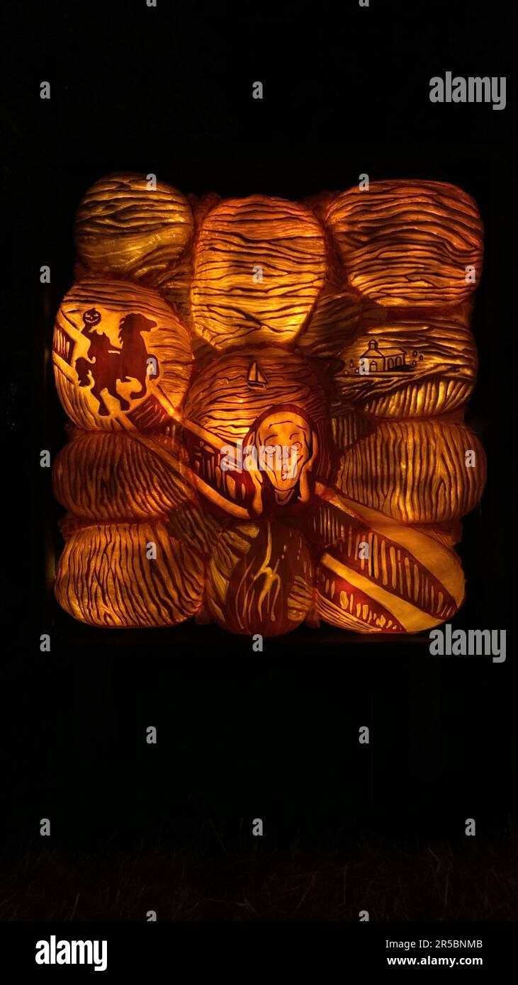 A Scream painting carved into a pumpkin illuminated by a warm candlelight, creating a spooky atmosphere Stock Photo