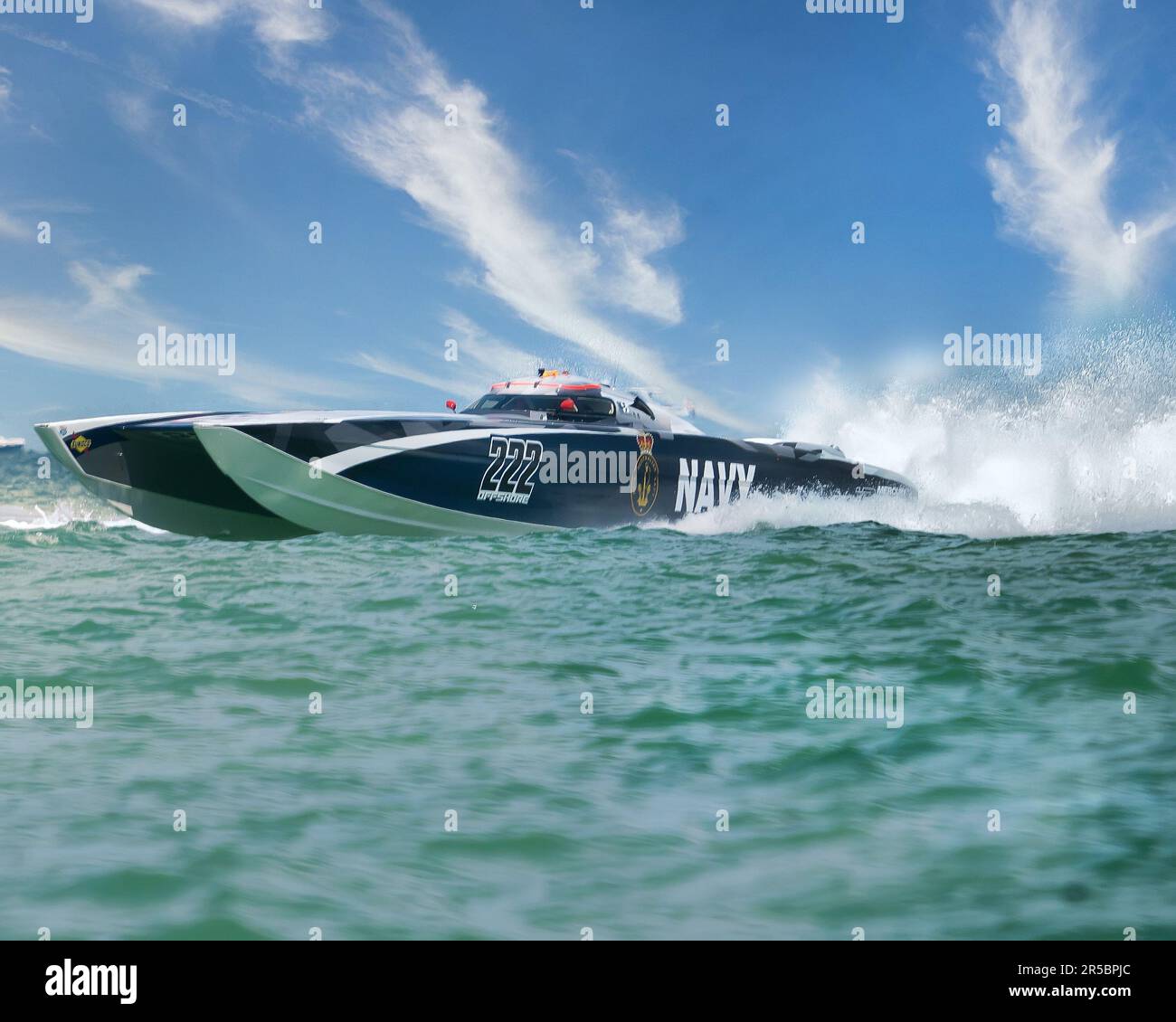 A small motorboat is racing across the ocean Stock Photo - Alamy