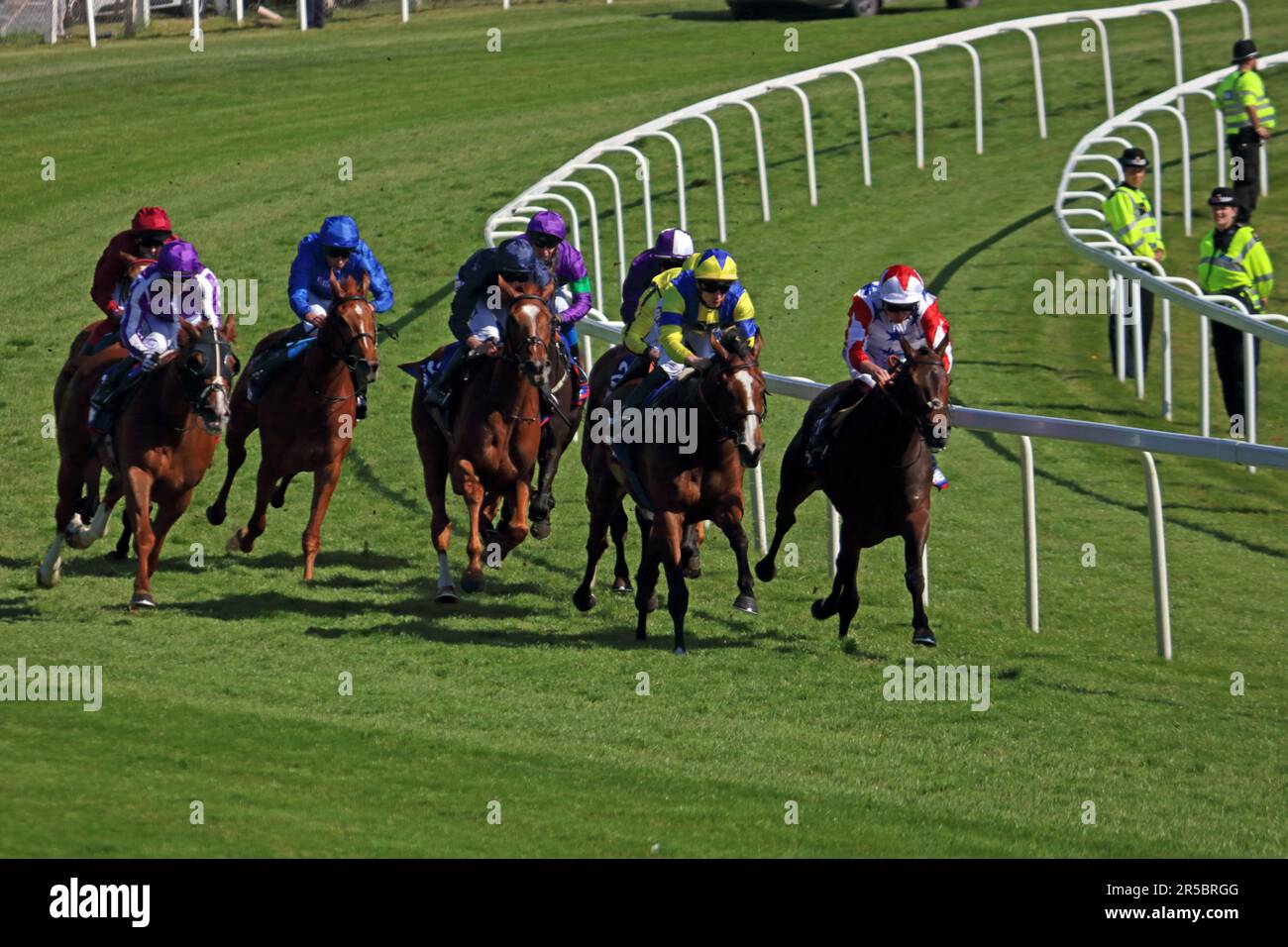 Epsom Downs Surrey, UK. 2nd June, 2023. The runners and riders come around Tattenham Corner in The Oaks ridden over 1 mile and 4 furlongs at Epsom Downs. Race won by Soul Sister ridden by Frankie Dettori in the red colours Credit: Julia Gavin/Alamy Live News Stock Photo