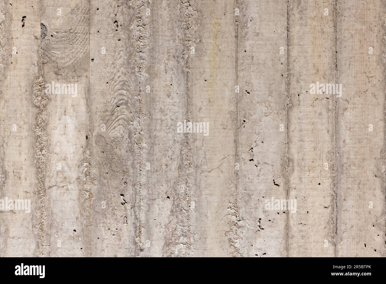 Grey-Brown Fair Faced Concrete Wall with Wood Linings Imprints Stock Photo