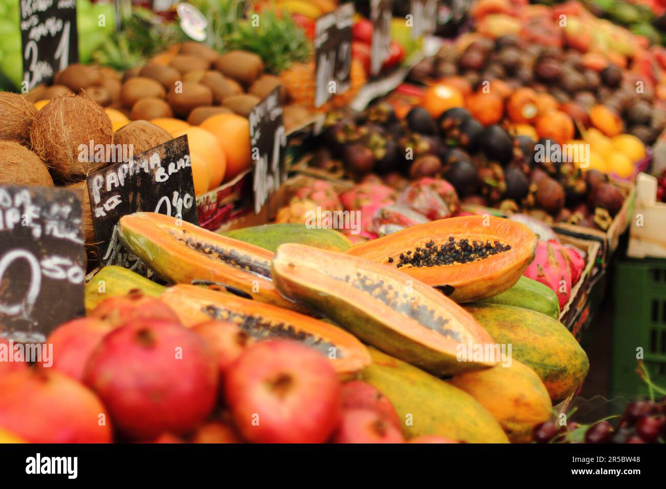 A vibrant market stall displaying a variety of colorful fruits and ...
