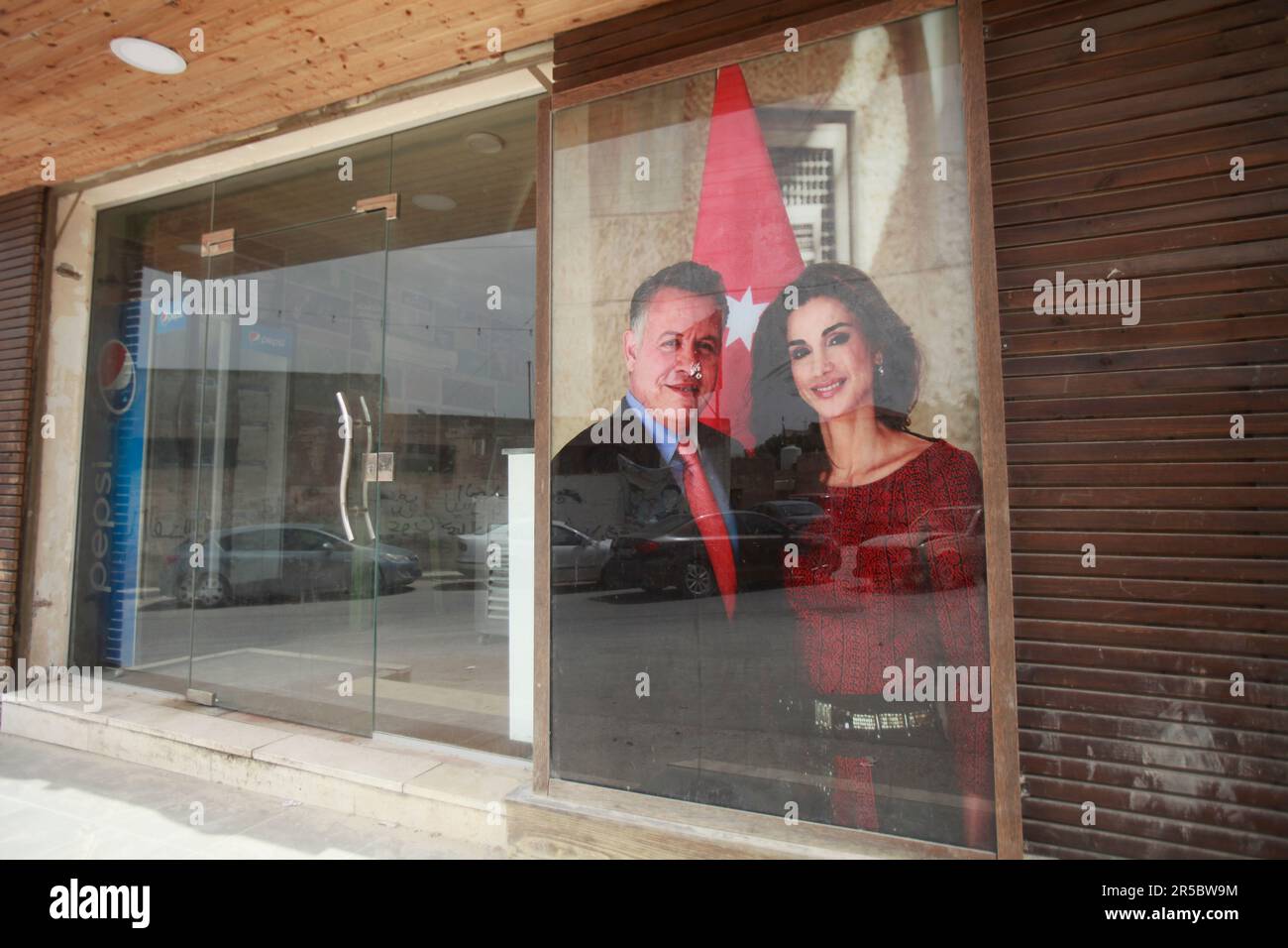 View of a poster of King Abdullah II of Jordan and his wife Queen Rania on a Palestinian store, during the occasion of their son Prince Hussein's wedding, in the middle of the market in the city of Nablus, north of the occupied West Bank Stock Photo