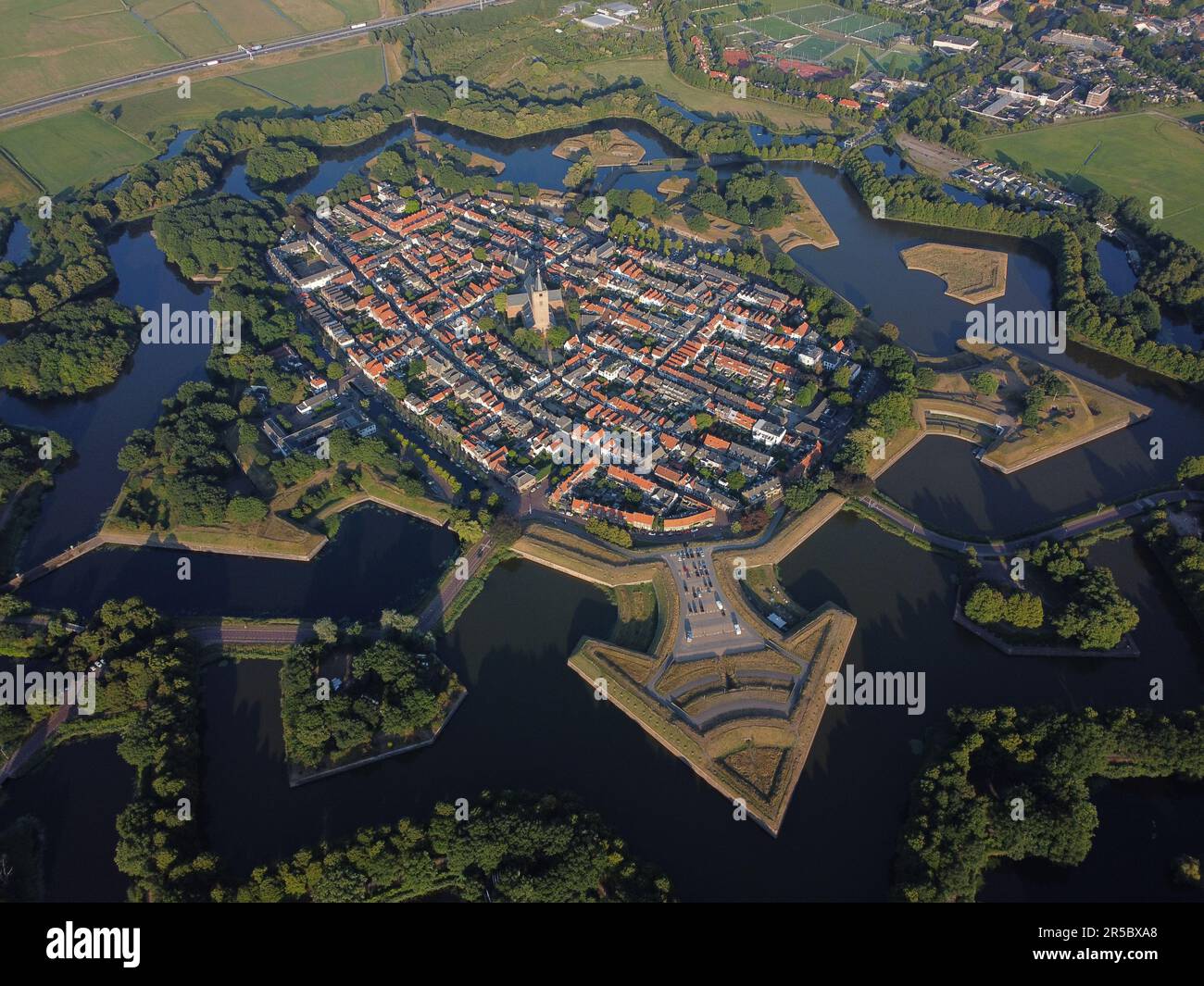 A scenic aerial view of the Fortress town of Naarden-Vesting surrounded by a tranquil lake Stock Photo