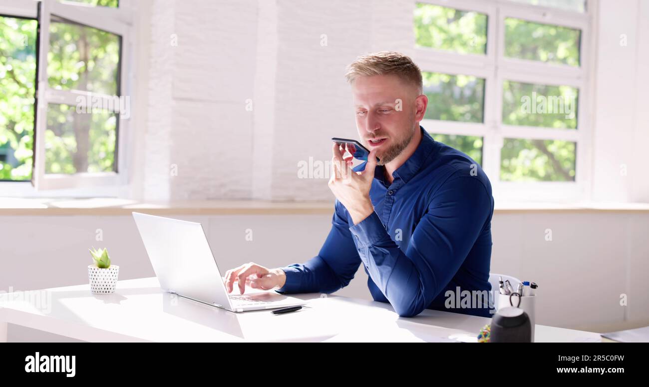 Young Man Using Voice Recognition Function On Mobile Phone Stock Photo