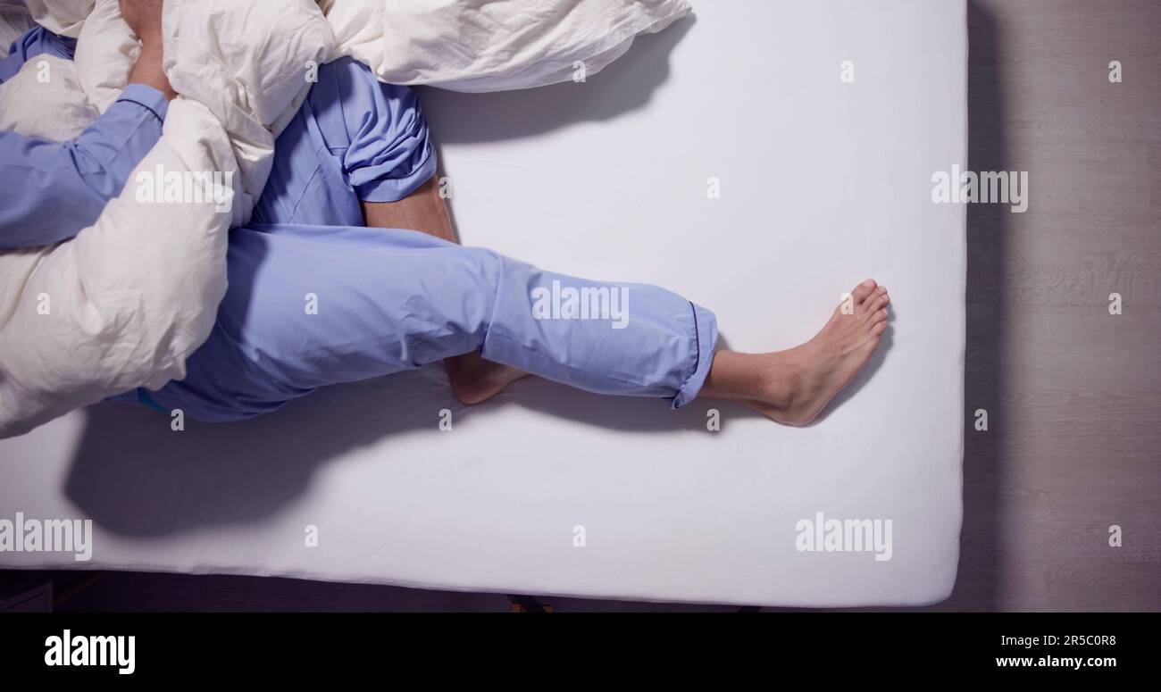 Man With RLS Restless Legs Syndrome. Sleeping In Bed Stock Photo Alamy