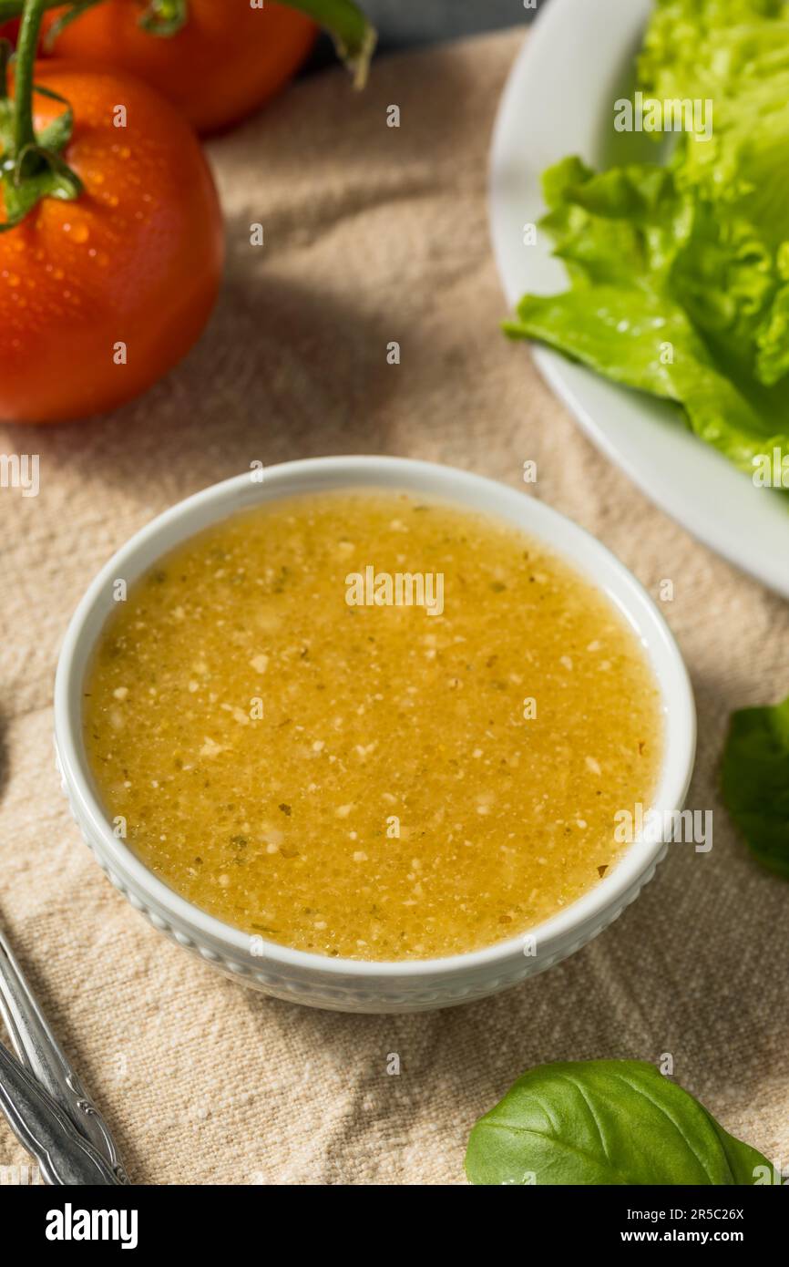 Organic Homemade Italian Salad Dressing with Garlic and Oil Stock Photo