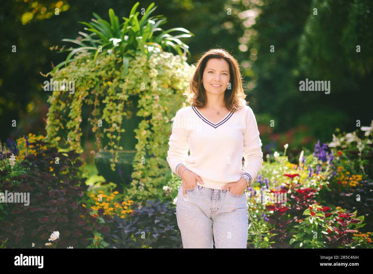 Outdoor portrait of happy beautiful 40 45 year old woman, wearing