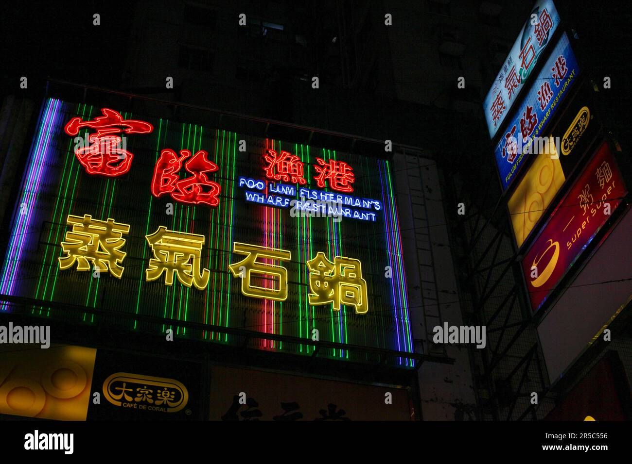 A vibrant night scene with neon lights of Hong Kong's Temple Street ...