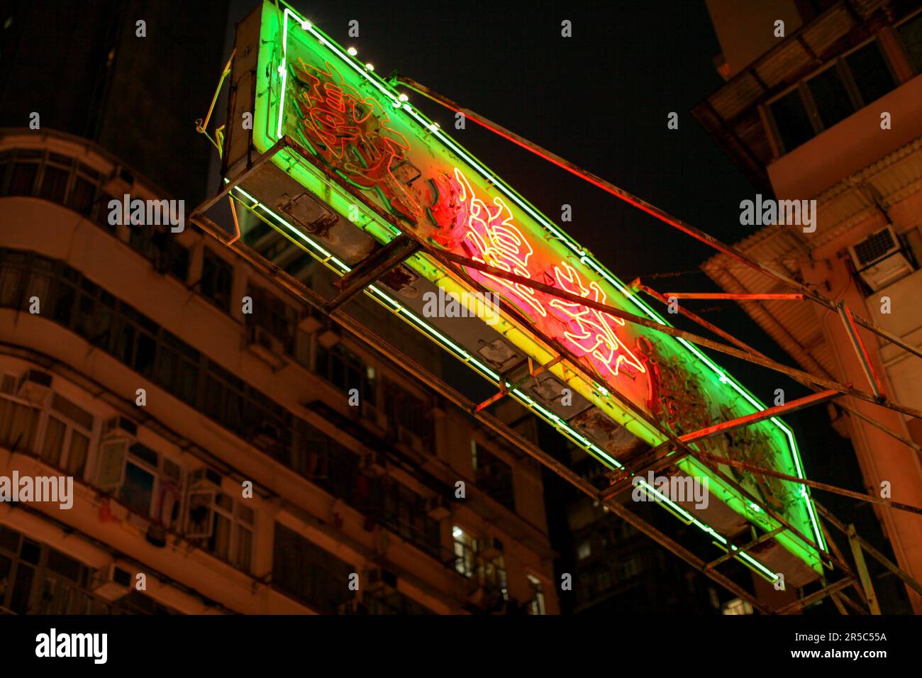 A vibrant night scene with neon lights of Hong Kong's Temple Street ...