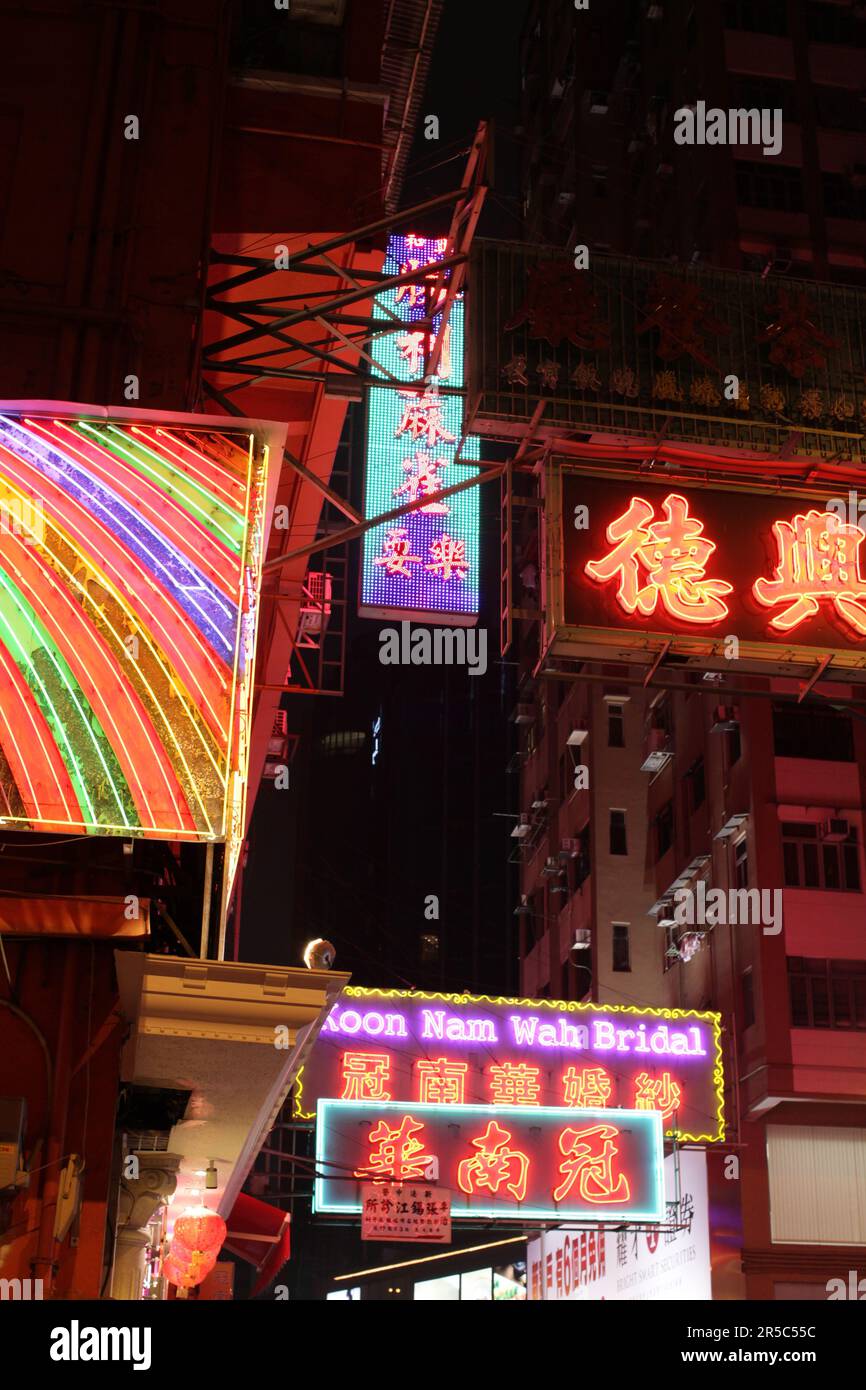 A vibrant night scene with neon lights of Hong Kong's Temple Street ...