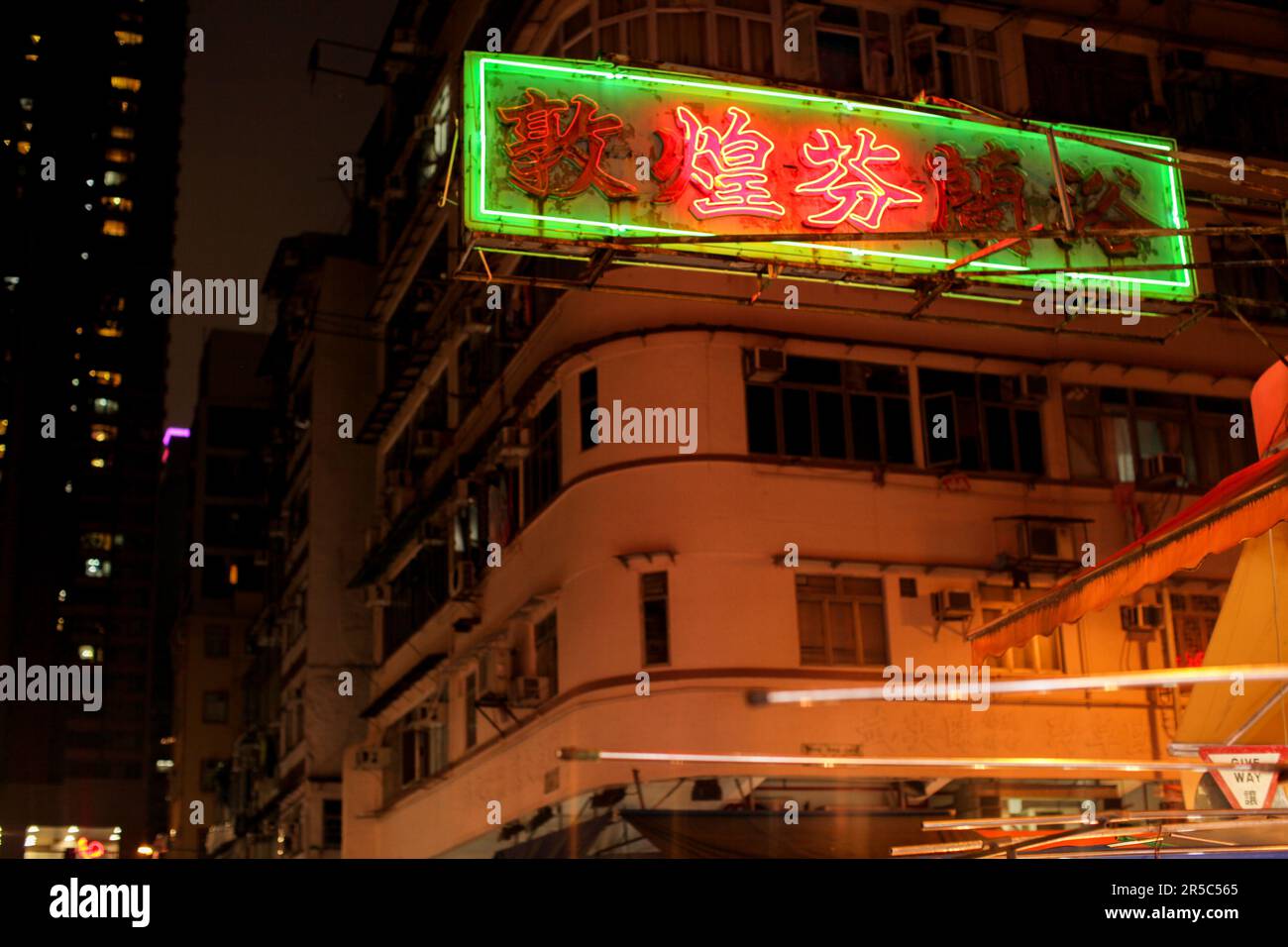 A vibrant night scene with neon lights of Hong Kong's Temple Street ...