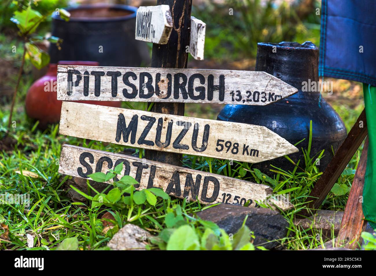Signposts with distances from Kutchire Lodge to Mzuzu, Scotland and Pittsburgh. Pittsburgh has a special meaning for Kutchire Lodge, because the first guests from this city in the USA have laid the foundation for all following investments of one of the few Malawian owned accommodations with their voluntarily increased overnight money. Malawi Liwonde National Park Stock Photo