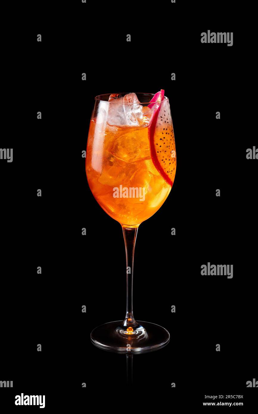 Glass of Aperol Spritz cocktail with Dragon fruit isolated on a black background. Fresh alcoholic cocktail. Stock Photo