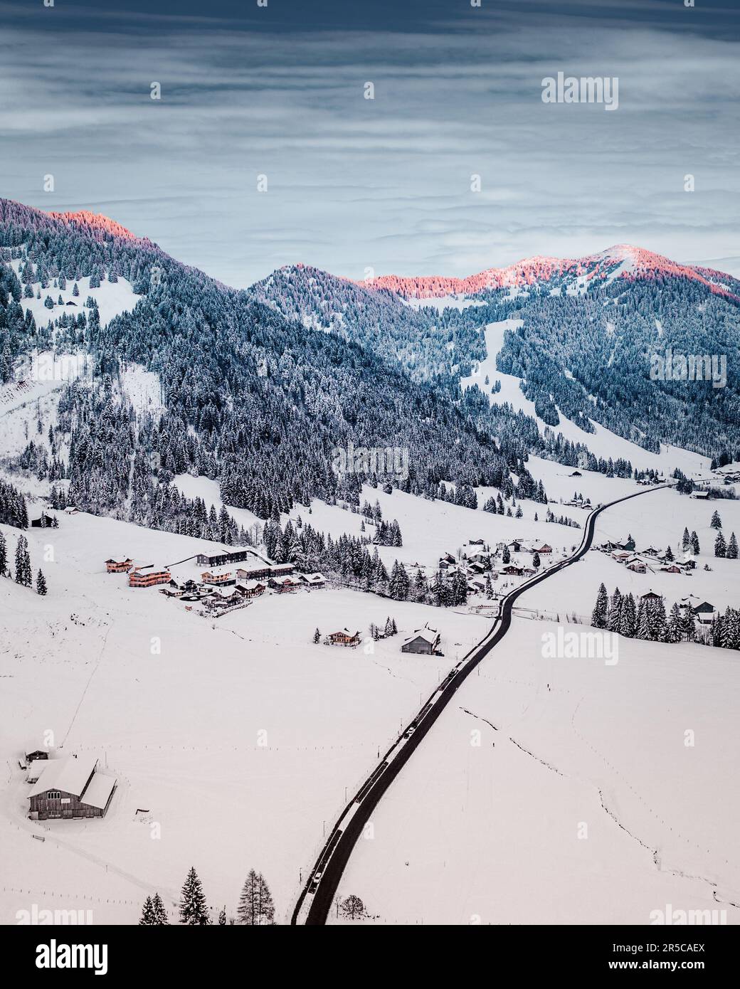 An aerial view of a stunning mountain range covered in snow Stock Photo ...