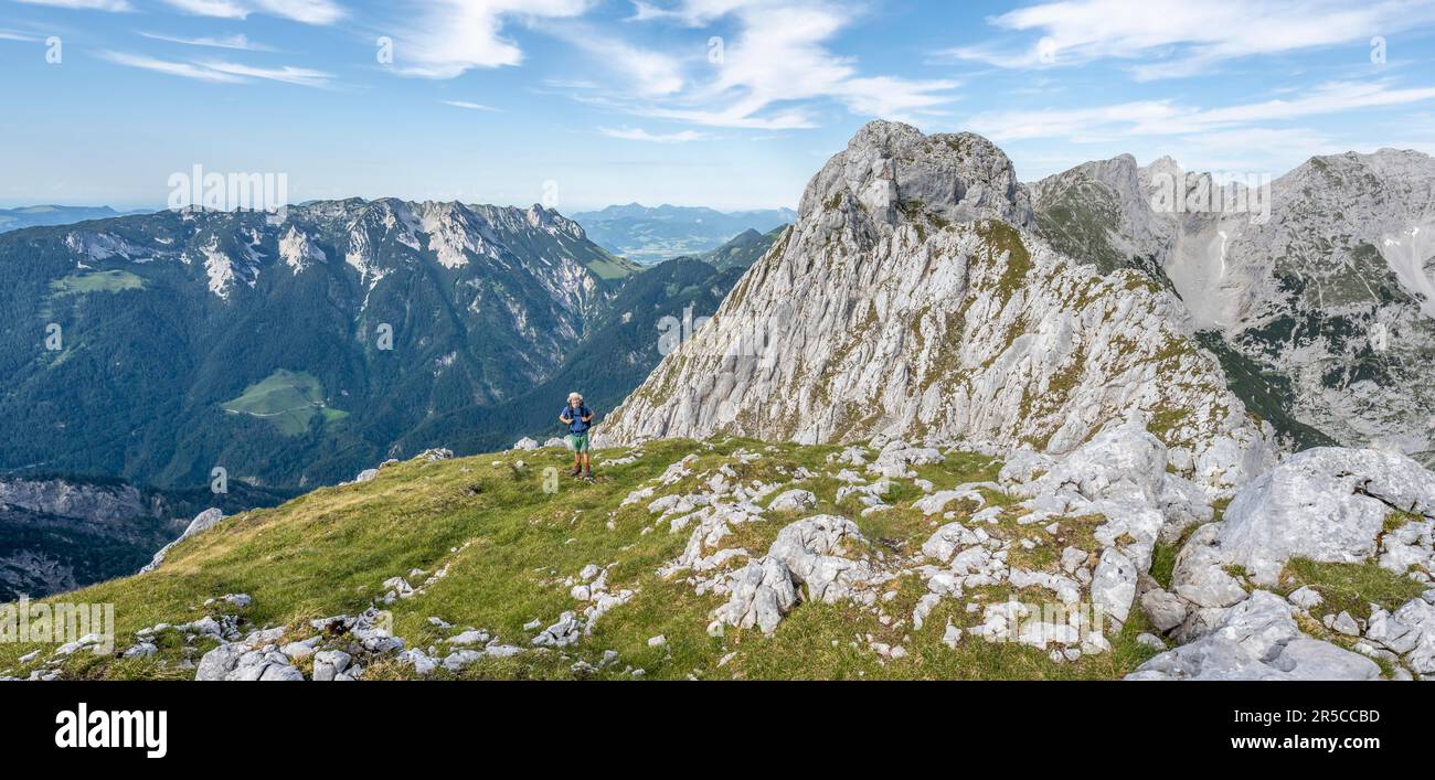 Mountaineer on a ridge path, crossing the Hackenkoepfe, rocky mountains ...