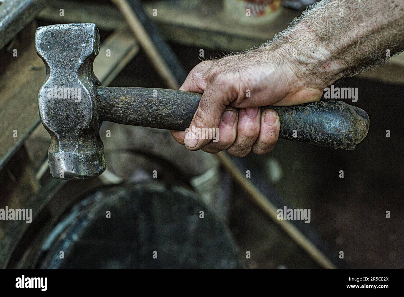 Cooper hand with hammer to work on whisky casks at the Speyside Cooperage in Craigellachie, Scotland Stock Photo