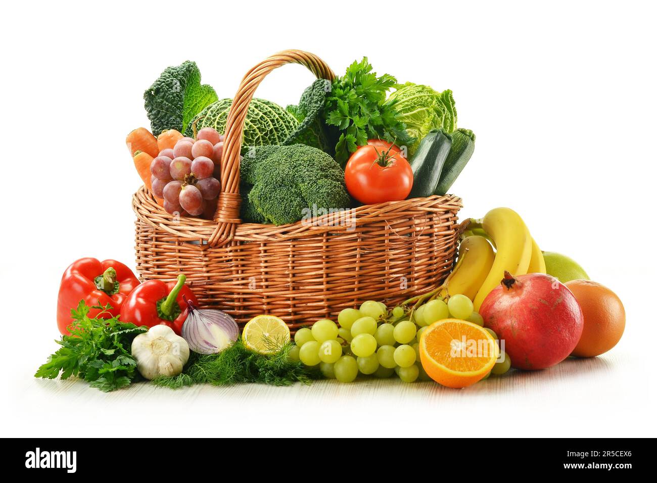 Composition with vegetables and fruits in wicker basket isolated on ...