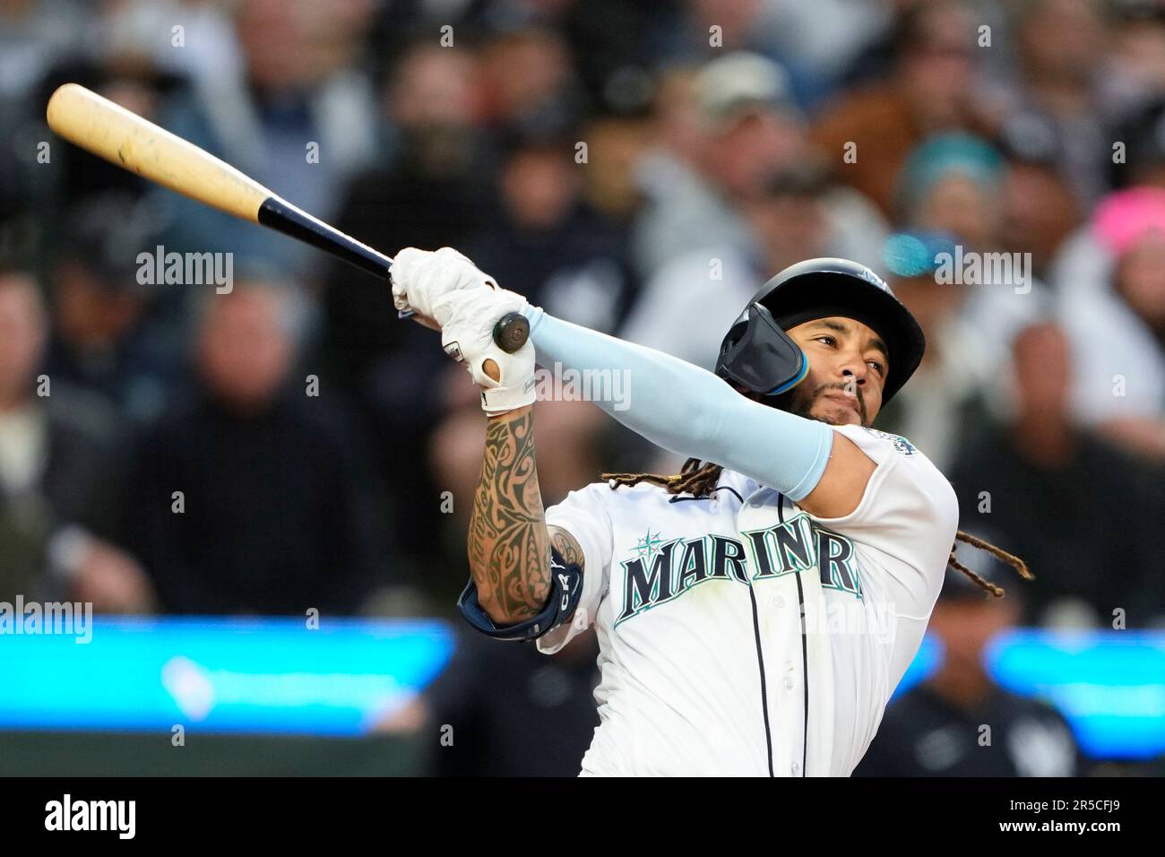 Seattle Mariners' J.P. Crawford follows through on a swing against