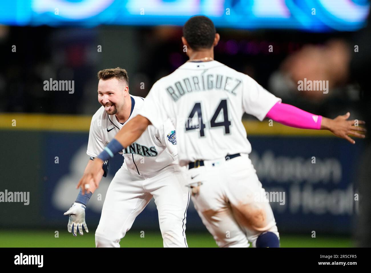 Seattle Mariners' Cal Raleigh reacts after hitting a walk-off single to win  the game 1-0 over the New York Yankees as teammate Julio Rodriguez (44)  runs towards him in a baseball game