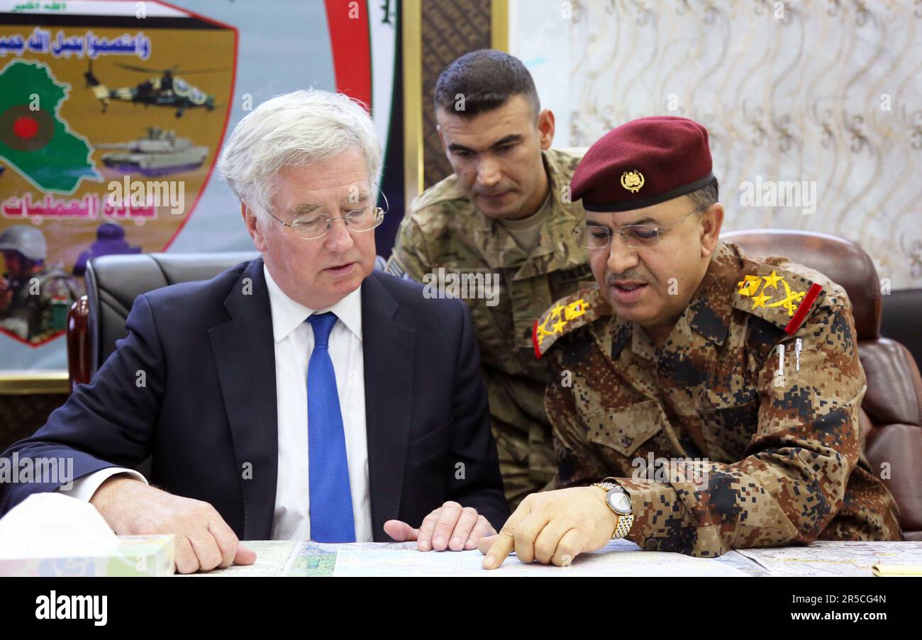 (Left) Michael Fallon, the United Kingdom Secretary of State for Defence, and Iraqi army Gen. Talib Al Kinani, the Combined Joint Operations Center commander, talk during his visit to Baghdad Aug. 3, 2015. Stock Photo