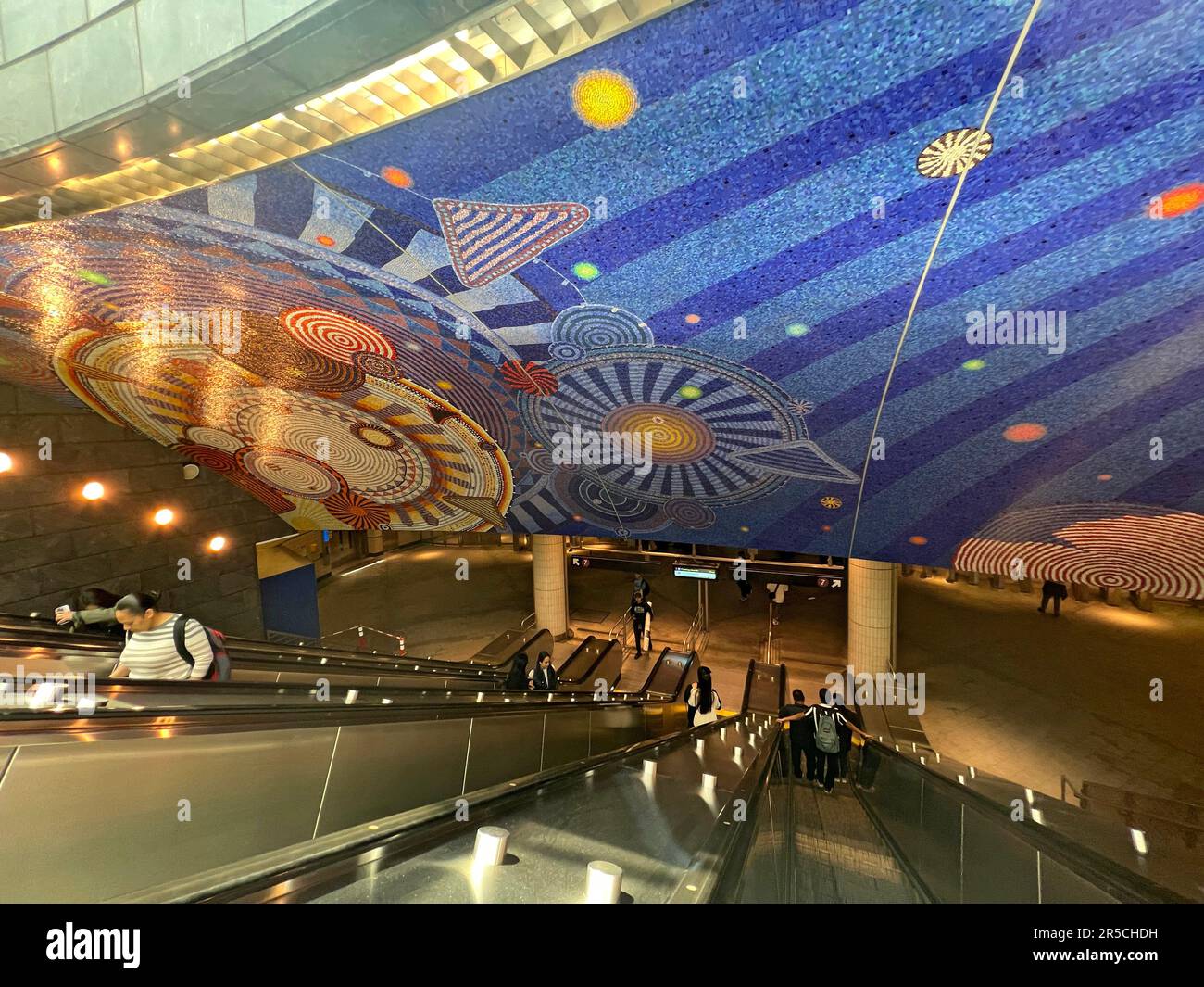 Escalator and mosaic tile ceiling at the Hudson Yards 7 train subway station at West 34th Street in Manhattan. Opened in September 2015. Artist is  Xenobia Bailey. The mandala-like patterns are called 'Funktional Vibrations' Stock Photo