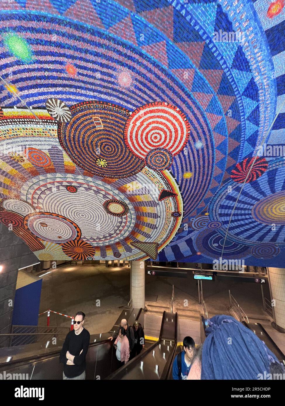 Escalator and mosaic tile ceiling at the Hudson Yards 7 train subway station at West 34th Street in Manhattan. Opened in September 2015. Artist is  Xenobia Bailey. The mandala-like patterns are called 'Funktional Vibrations' Stock Photo