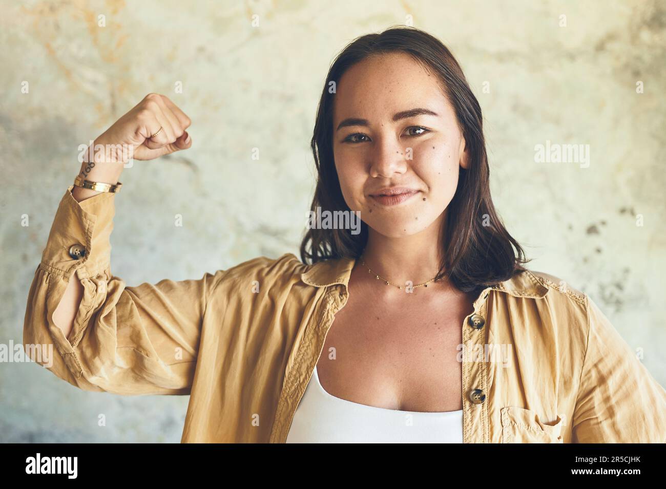 Women are made of magic. Portrait of a young woman flexing her biceps ...