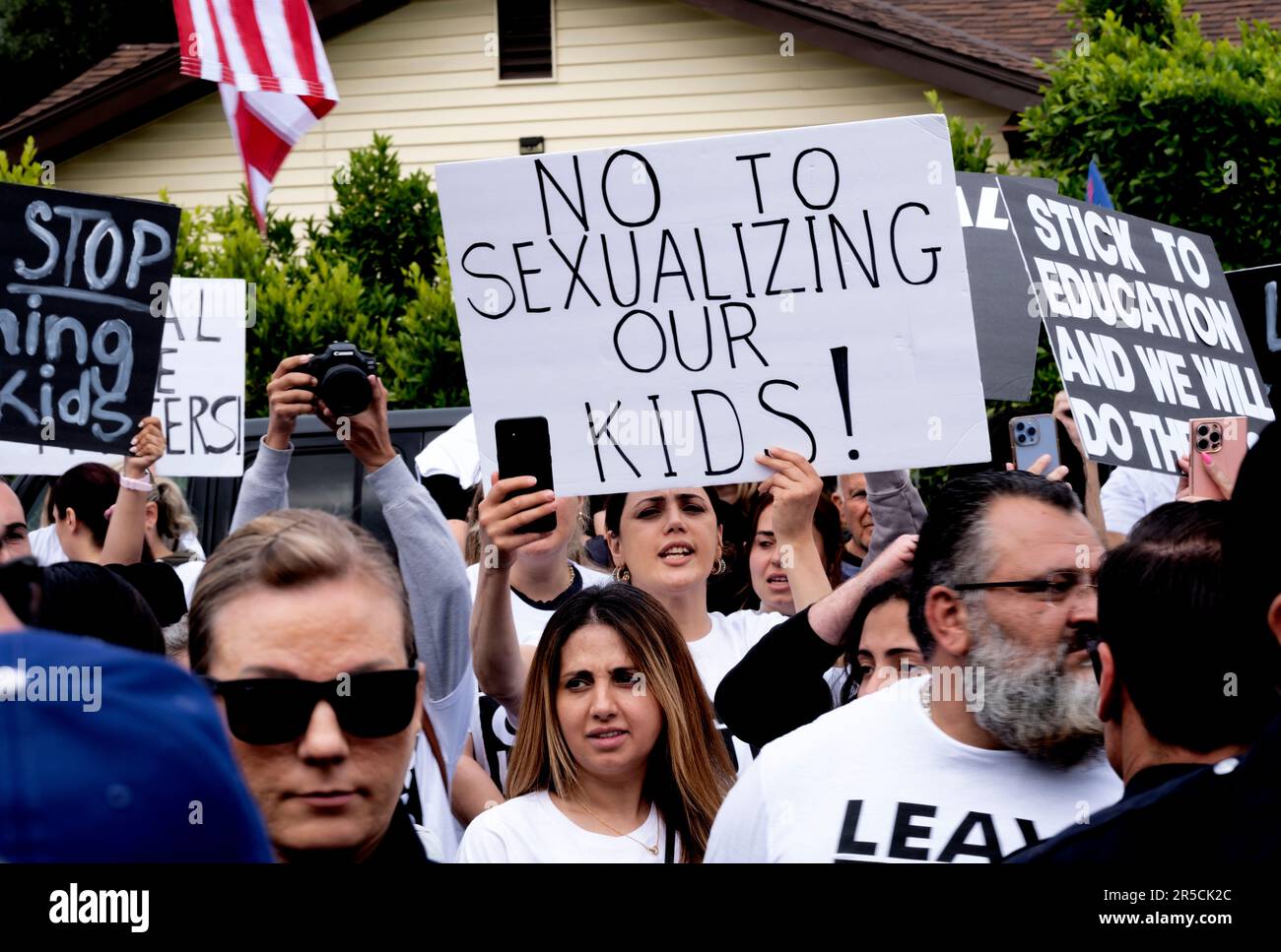 Protesters shout slogans and carry signs as Los Angeles police officers ...