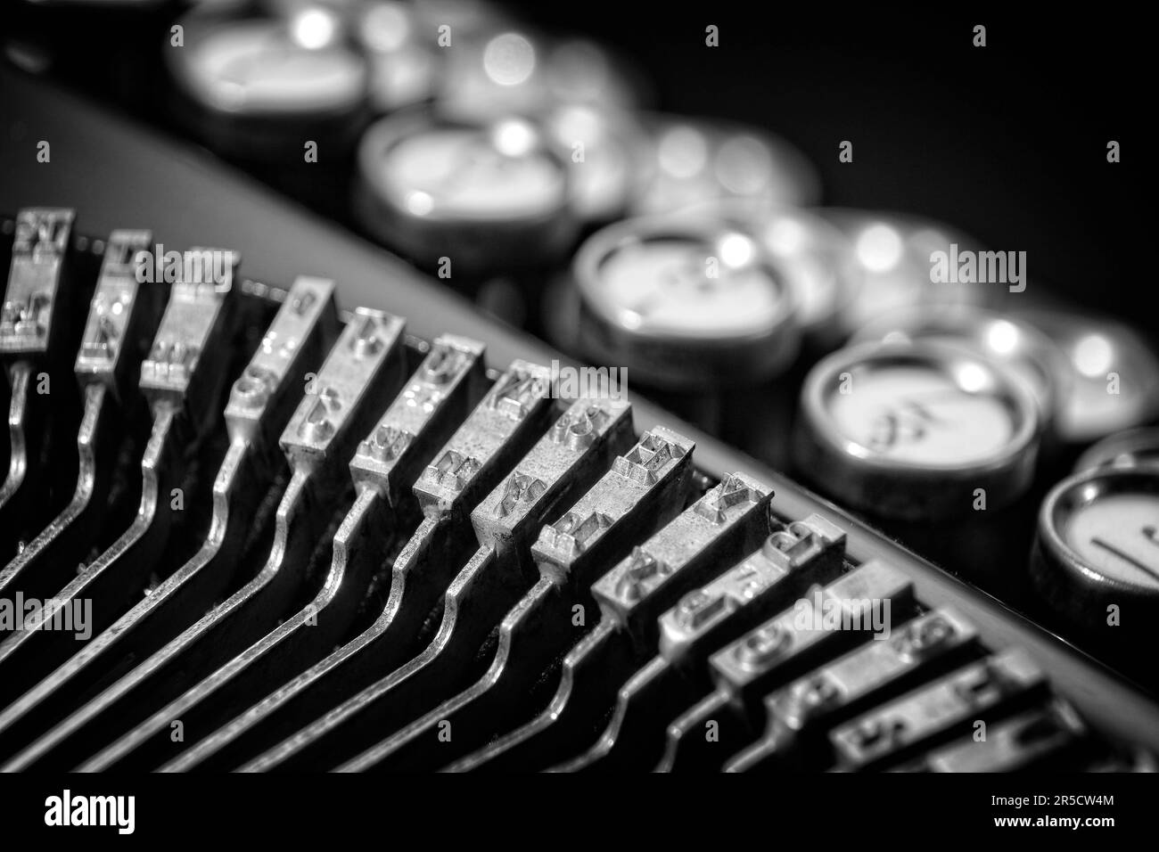 Vintage Keyboarding: Classic 1923 typewriter with bokeh keyboard and black background. When framed it's suitable for business offices and hotel rooms. Stock Photo