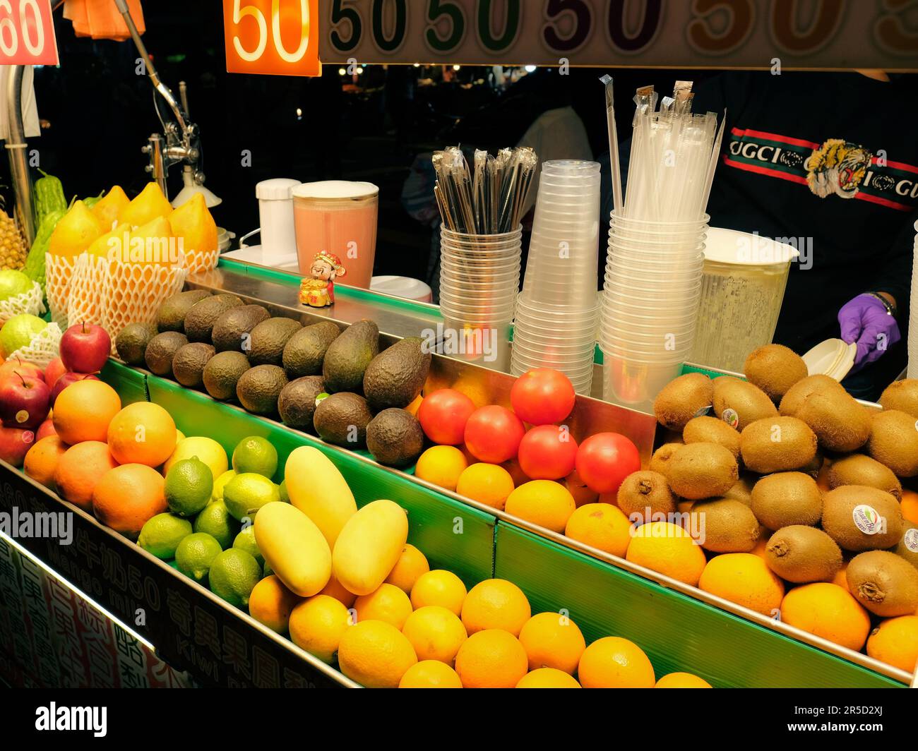 Fruit juice and smoothie stand at Huaxi Street Tourist Night Market in Taipei, Taiwan; natural drinks food cart; traditional Taiwanese food. Stock Photo