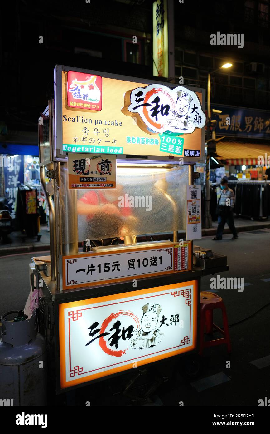 Scallion pancake stand at Huaxi Street Tourist Night Market in Taipei, Taiwan; street food cart and vendor; traditional Taiwanese food. Stock Photo