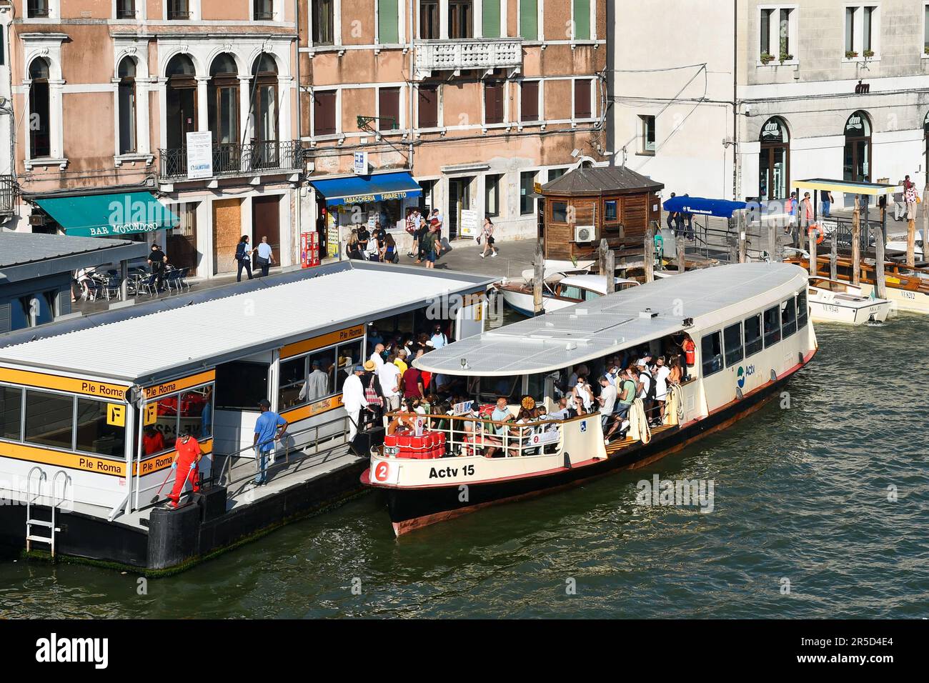 High-angle view of the Piazzale Roma vaporetto stop with a waterbus crowded with tourists on the Grand Canal in august, Venice, Veneto, Italy Stock Photo