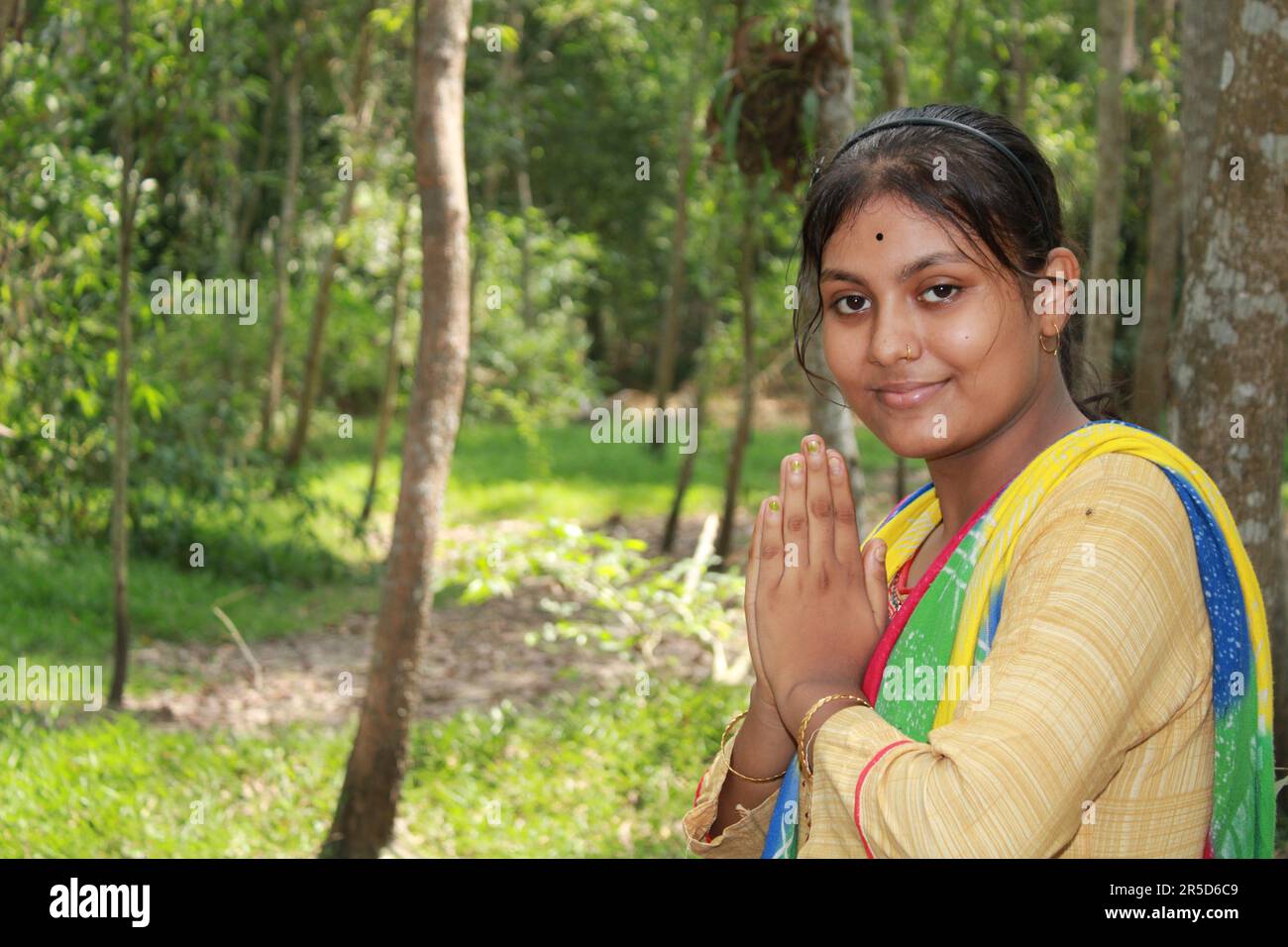 Namaste! Portrait of happy Indian Teenage girl village, India Stock Photo