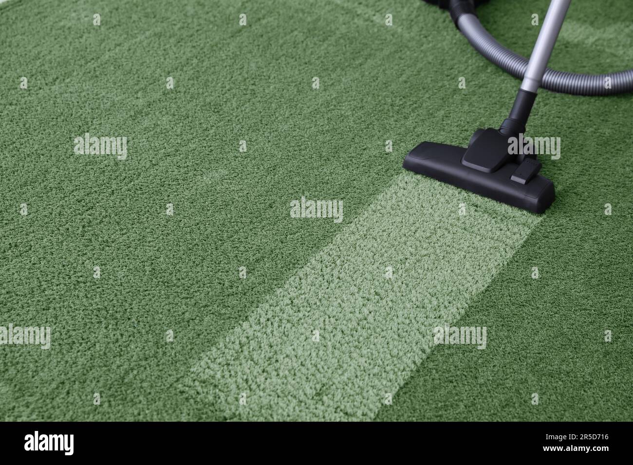 Vacuuming carpet. Clean area after using device, closeup Stock Photo