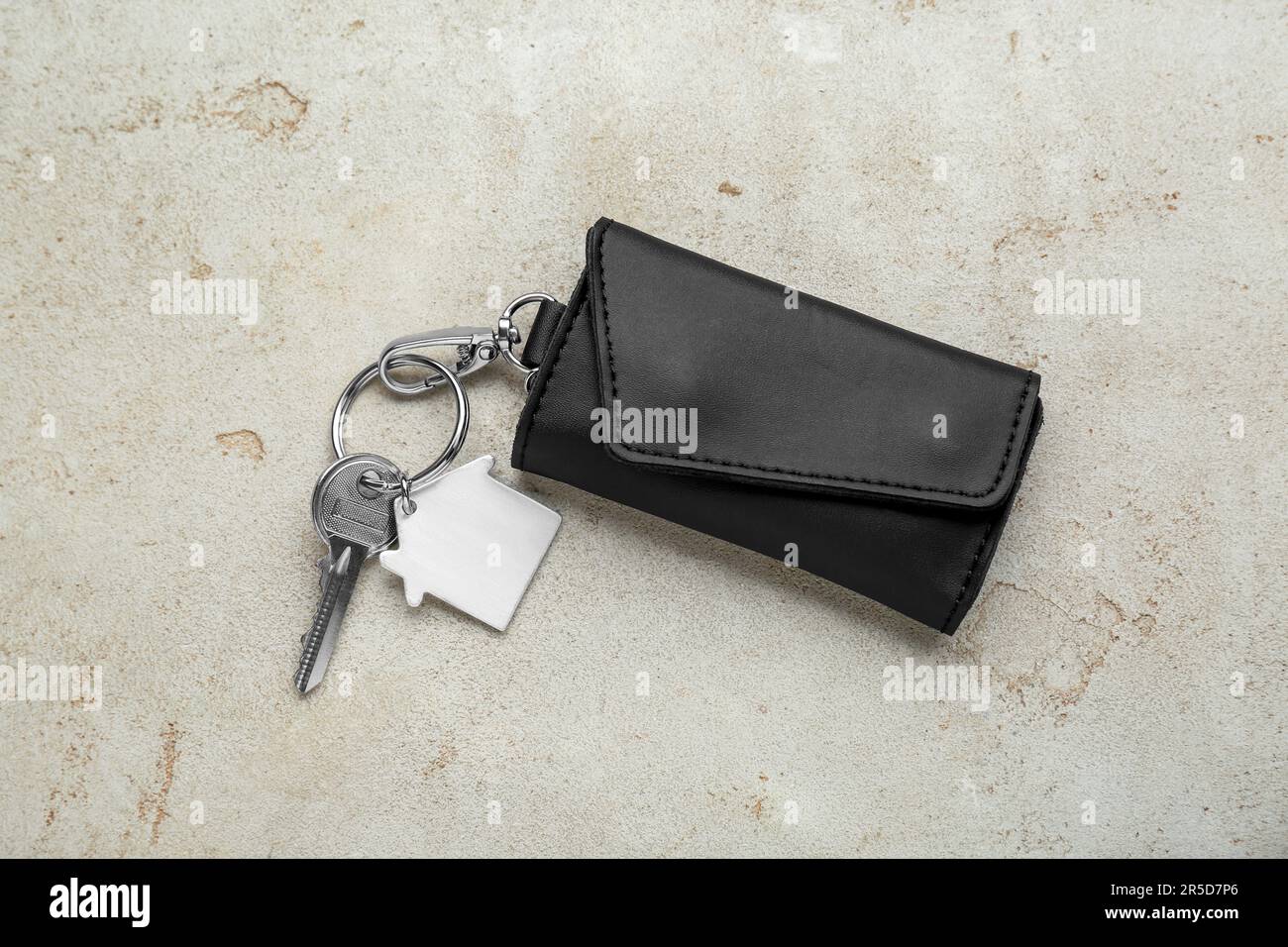 Leather case with key on light grey table, top view Stock Photo