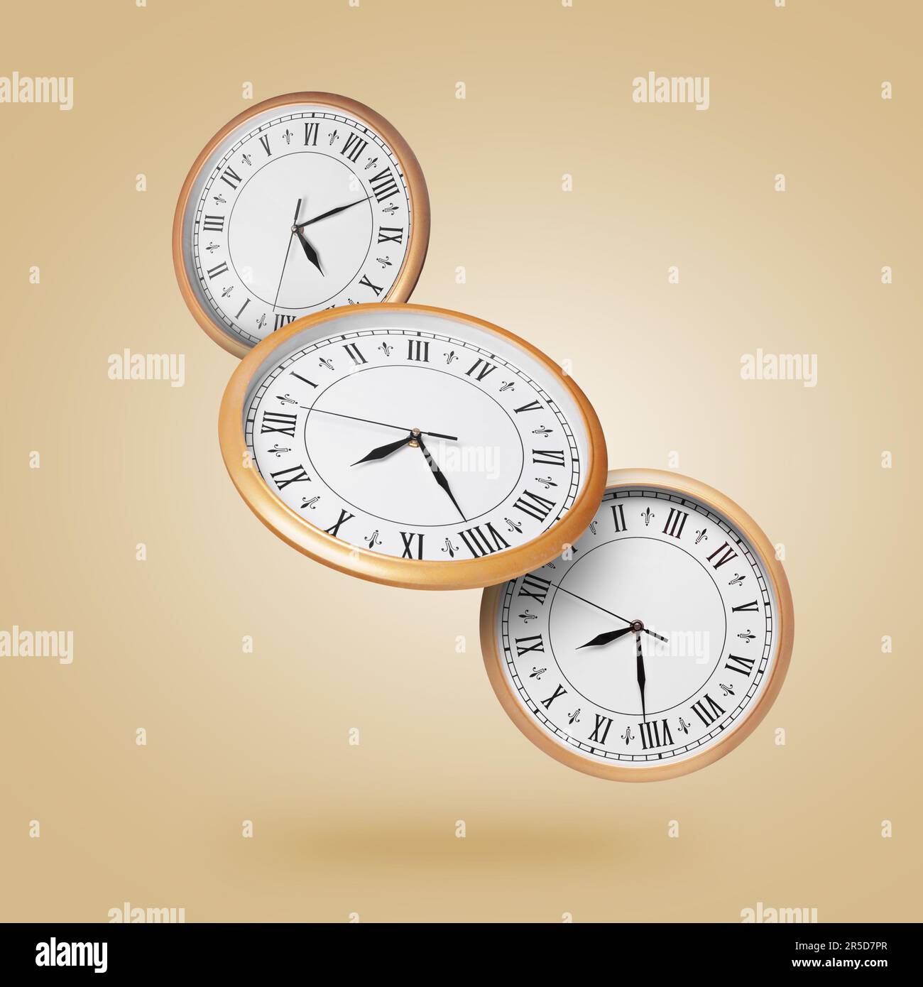 Stylish clocks falling on pale orange background Stock Photo Alamy