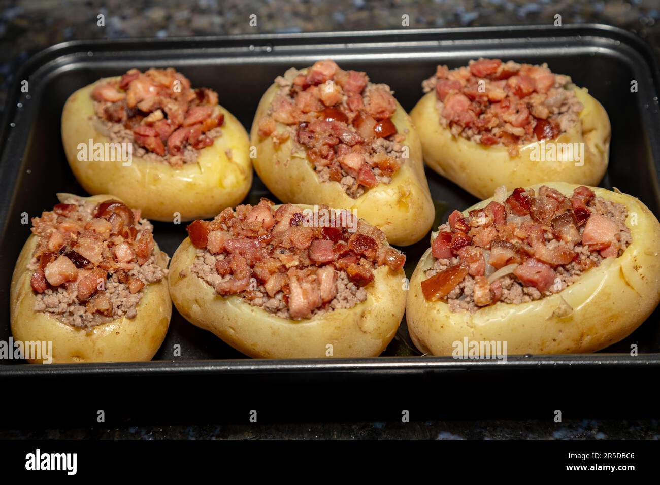 Typical potato stuffed with ground meat and bacon and roasted Stock Photo