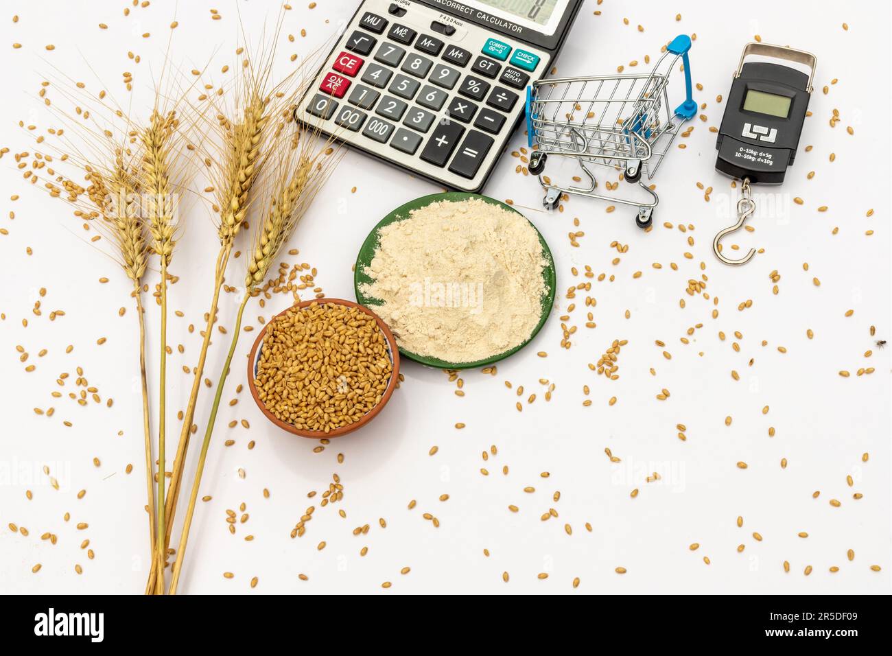 Wheat grains, wheat flour and wheat ears with weight scale and tools on