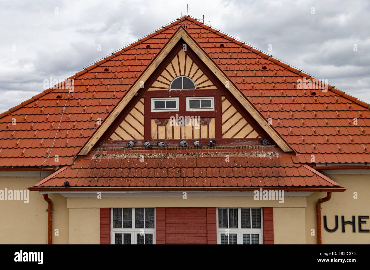 Painting house gable and tiled roof Stock Photo