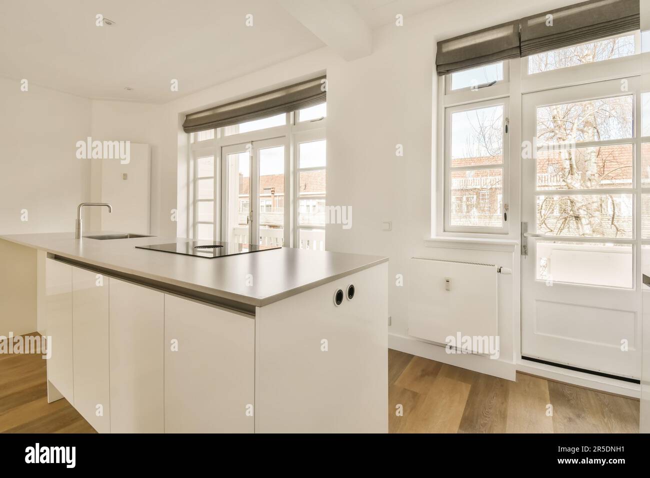 Curated visual reference: Gallery Detail: A Kitchen Area With White Cabinets And Wood Flooring In