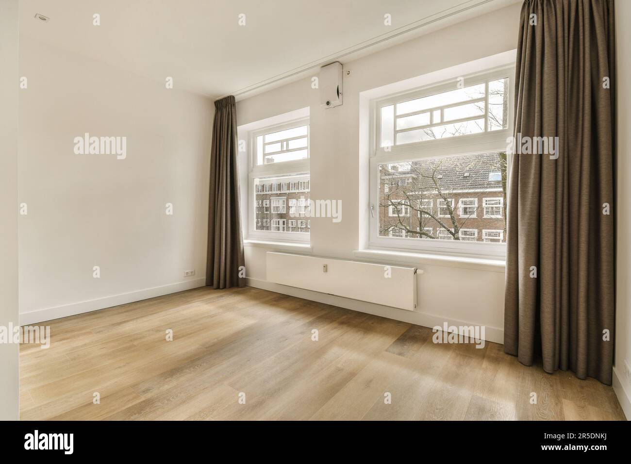 Window Room Out an empty room with wood flooring and two large windows in the photo is ...